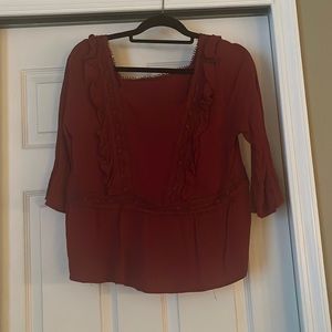 Red long sleeve blouse with lace and ruffle accents